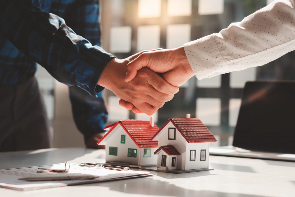 Two men shaking hands over a property deal